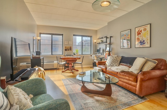 living room with wood finished floors and vaulted ceiling