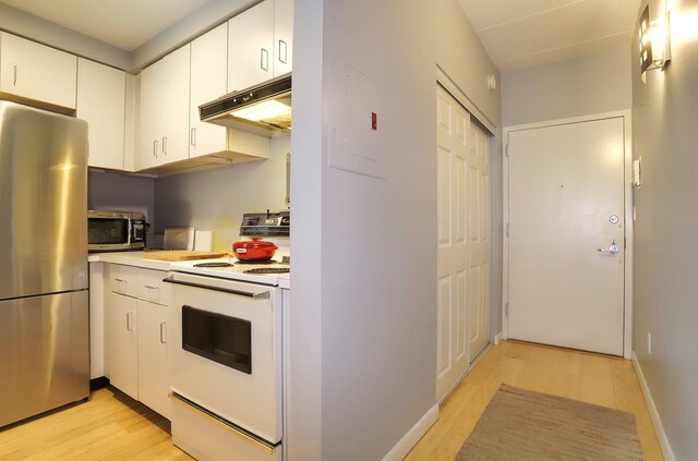 463 1st St Unit 3B, Hoboken, NJ 07030 - kitchen featuring stainless steel appliances, under cabinet range hood, light countertops, and light wood-type flooring
