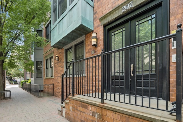 view of exterior entry with french doors and brick siding