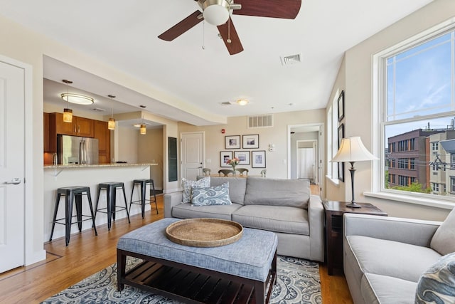 living area featuring wood finished floors and a ceiling fan