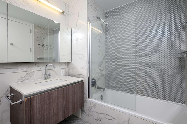 160 1st St Unit 1013, Jersey City, NJ 07302 - bathroom with vanity, a combined bath / shower with marble appearance, and tile walls