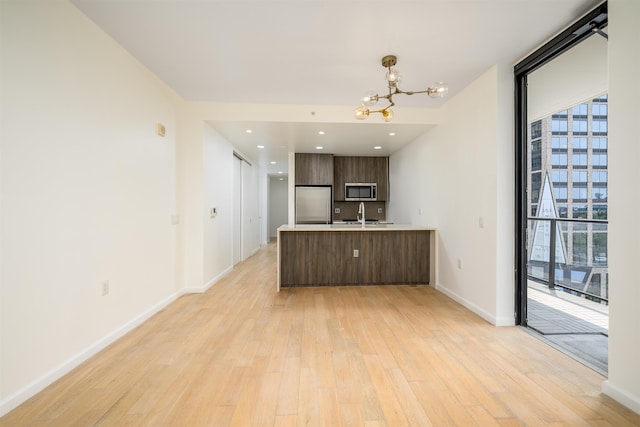 160 1st St Unit 1013, Jersey City, NJ 07302 - kitchen featuring stainless steel appliances, modern cabinets, plenty of natural light, light countertops, and expansive windows