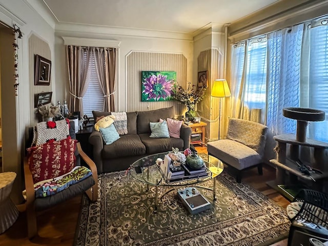 living area with ornamental molding and wood finished floors