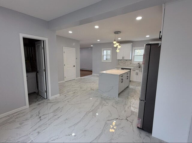 187 Lembeck Ave, Jersey City, NJ 07305 - kitchen with freestanding refrigerator, a center island, white cabinetry, recessed lighting, and light countertops