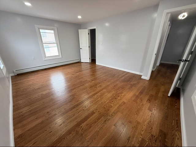187 Lembeck Ave, Jersey City, NJ 07305 - spare room with a baseboard radiator, dark wood-style floors, and recessed lighting