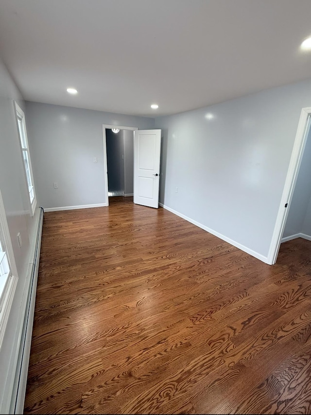 187 Lembeck Ave, Jersey City, NJ 07305 - spare room with a baseboard heating unit, dark wood-style flooring, and recessed lighting