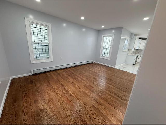 187 Lembeck Ave, Jersey City, NJ 07305 - spare room with a baseboard heating unit, wood finished floors, and recessed lighting