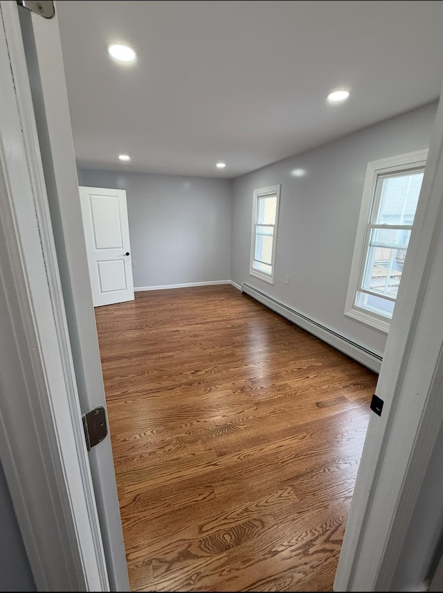 187 Lembeck Ave, Jersey City, NJ 07305 - empty room with a baseboard radiator, dark wood-style floors, and recessed lighting