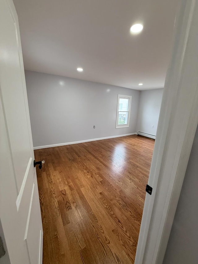 187 Lembeck Ave, Jersey City, NJ 07305 - spare room with wood finished floors, recessed lighting, and baseboard heating