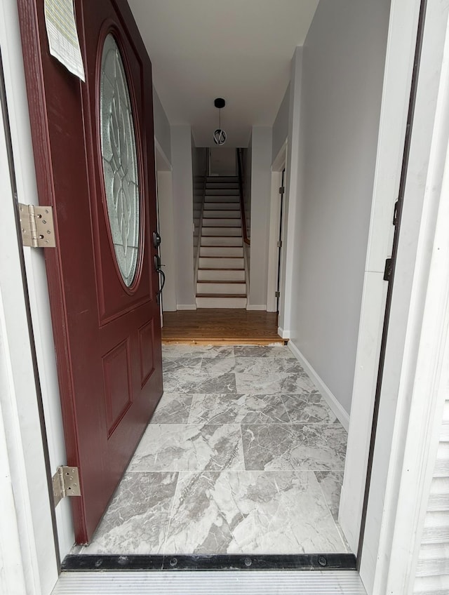 187 Lembeck Ave, Jersey City, NJ 07305 - foyer entrance featuring marble look tiles and stairway