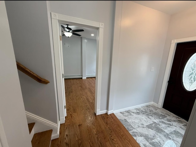 187 Lembeck Ave, Jersey City, NJ 07305 - entryway featuring baseboard heating, wood finished floors, ceiling fan, and stairway