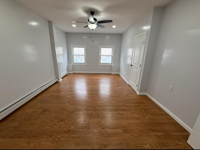 187 Lembeck Ave, Jersey City, NJ 07305 - spare room featuring a baseboard radiator, ceiling fan, wood finished floors, and recessed lighting