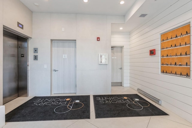 202 Merseles St Unit 504, Jersey City, NJ 07302 - corridor featuring elevator, tile patterned floors, wooden walls, and recessed lighting