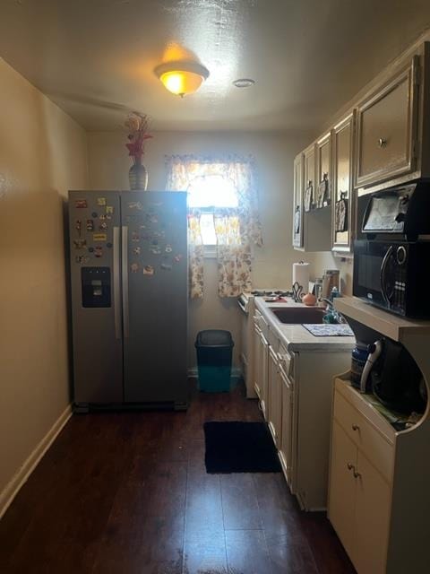 kitchen featuring dark wood-type flooring and stainless steel fridge with ice dispenser