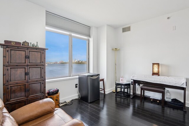 8100 River Rd Unit 1101, North Bergen, NJ 07047 - living area with baseboards, a healthy amount of sunlight, visible vents, and dark wood-type flooring