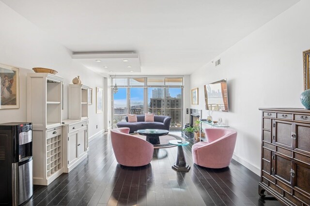 8100 River Rd Unit 1101, North Bergen, NJ 07047 - living area featuring baseboards, dark wood-style floors, visible vents, and floor to ceiling windows