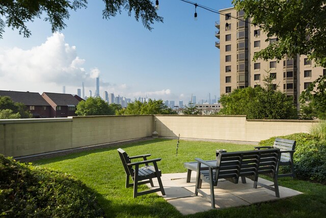 8100 River Rd Unit 1101, North Bergen, NJ 07047 - surrounding community featuring a yard, a city view, a fenced backyard, and a patio