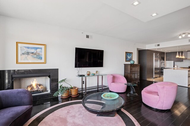 8100 River Rd Unit 1101, North Bergen, NJ 07047 - living area featuring a premium fireplace, visible vents, and wood finished floors