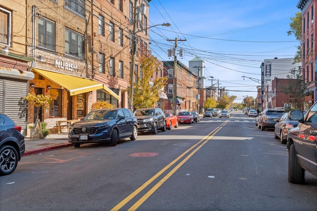 view of street with street lights, curbs, and sidewalks