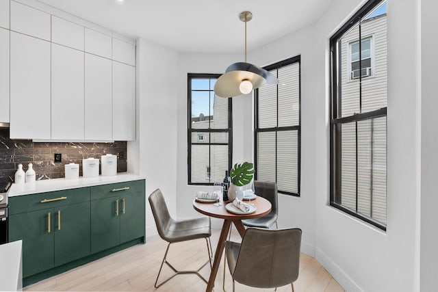 dining room featuring light wood-type flooring and baseboards