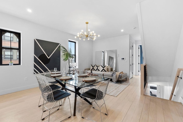 dining room featuring a notable chandelier, recessed lighting, baseboards, and light wood finished floors