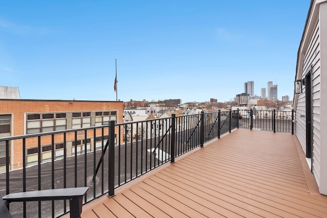 wooden terrace featuring a city view