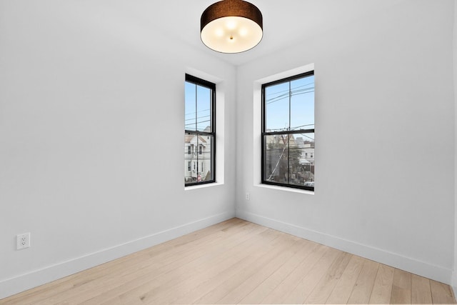 empty room with wood finished floors and baseboards