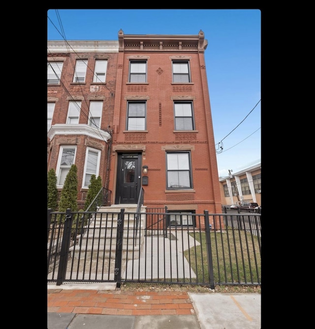 view of building exterior with a fenced front yard