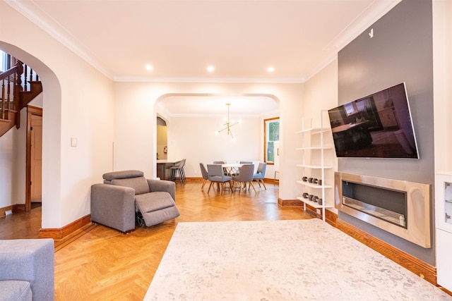 living room with parquet flooring, an inviting chandelier, and ornamental molding