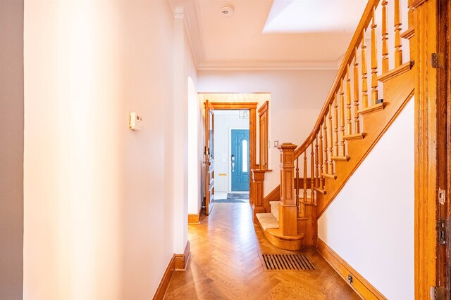 hall featuring parquet flooring and crown molding