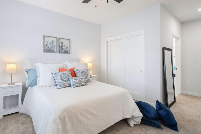 carpeted bedroom with a closet and ceiling fan