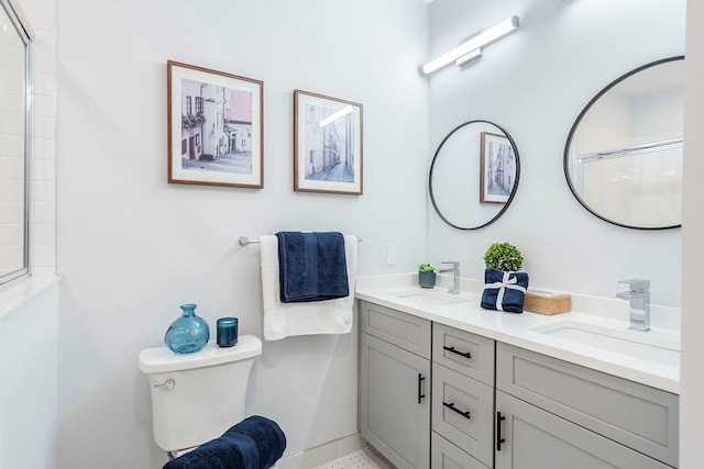 bathroom with vanity, toilet, and a shower with shower door