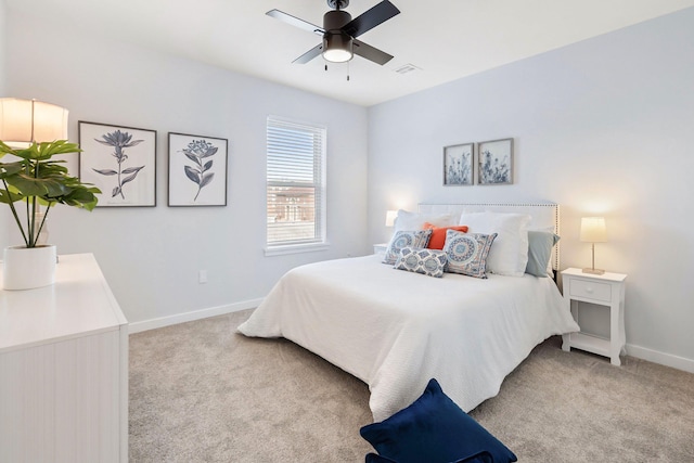 bedroom with ceiling fan and light colored carpet