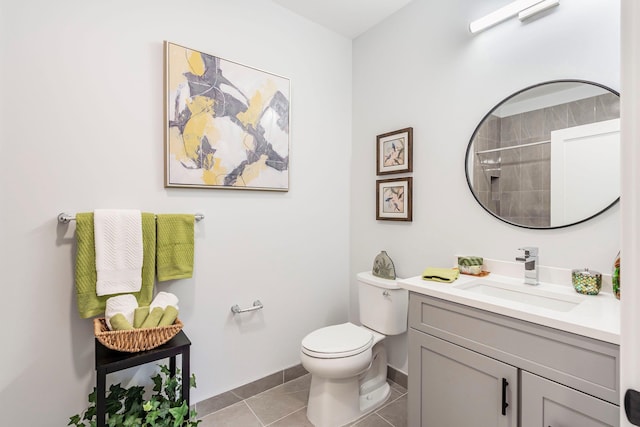 bathroom featuring tile patterned floors, vanity, toilet, and a shower