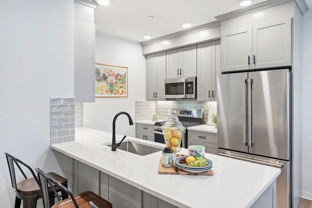 kitchen featuring a kitchen breakfast bar, kitchen peninsula, and appliances with stainless steel finishes