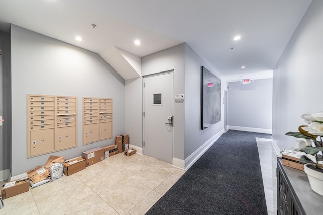 interior space with a mail area and light tile patterned floors