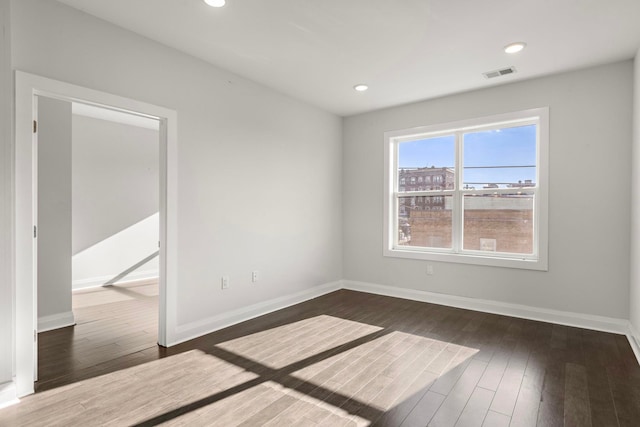 empty room featuring dark hardwood / wood-style flooring