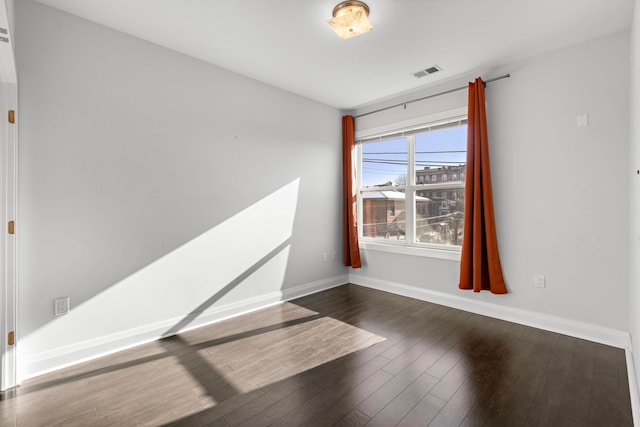 unfurnished room featuring dark wood-type flooring