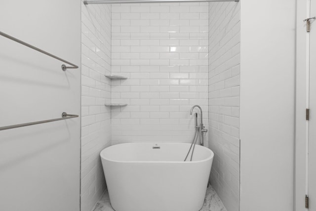 bathroom featuring a tub to relax in and tile walls