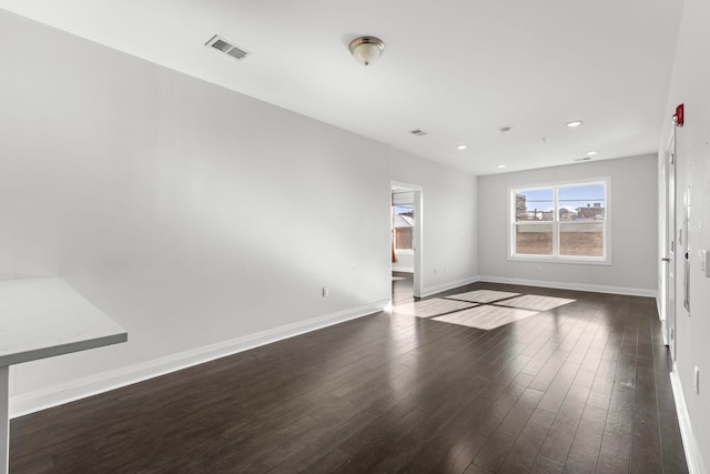 empty room with dark wood-type flooring