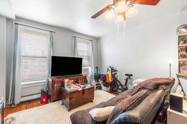living room featuring wood-type flooring and ceiling fan