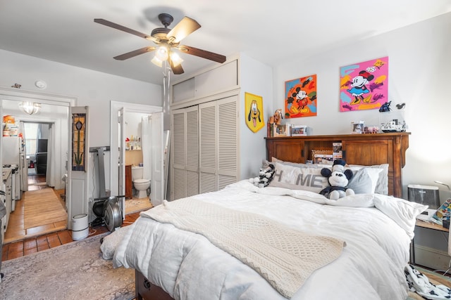 bedroom with ceiling fan, ensuite bathroom, a closet, and wood finished floors