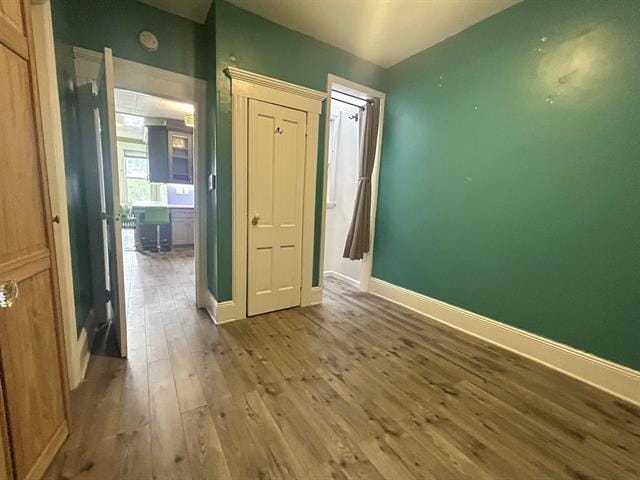 unfurnished bedroom with hardwood / wood-style flooring