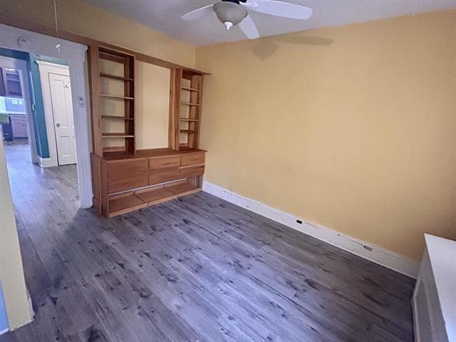 spare room with ceiling fan and dark hardwood / wood-style flooring