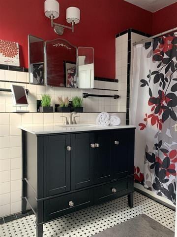 bathroom featuring tile walls, walk in shower, and vanity