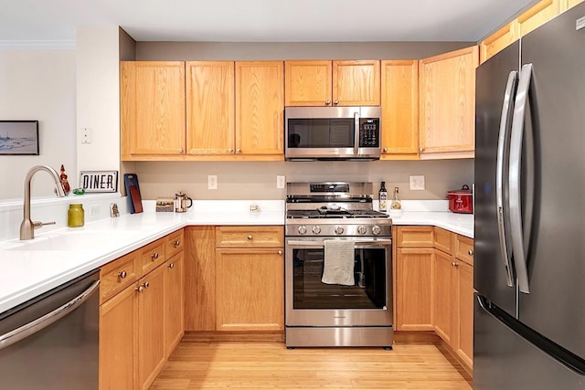 812 Grand St Unit 208, Hoboken, NJ 07030 - kitchen with stainless steel appliances, light wood-style flooring, and light brown cabinets