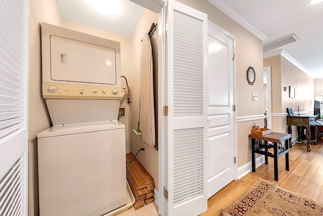 812 Grand St Unit 208, Hoboken, NJ 07030 - laundry room with stacked washer and clothes dryer, ornamental molding, light wood finished floors, and an office area