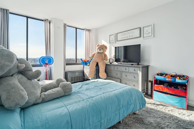 bedroom with an AC wall unit