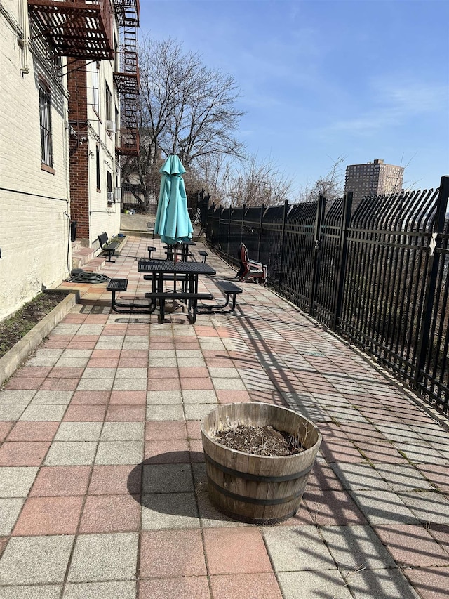 view of patio / terrace featuring fence and an outdoor fire pit