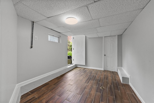 74 Storms Ave, Jersey City, NJ 07306 - below grade area featuring dark wood finished floors, baseboards, and a drop ceiling